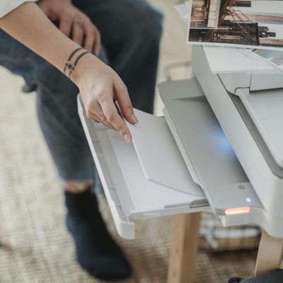 Woman printing photos on paper at home